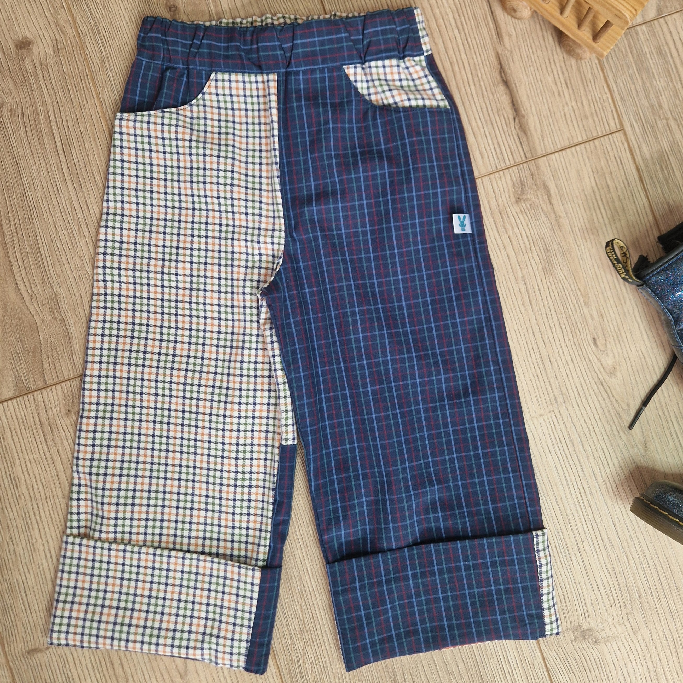 Plaid pants on a wooden floor